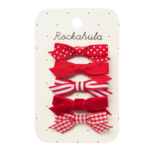 Set of red hair bows with different patterns on a Rockahula branded card.