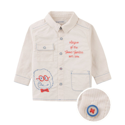 Children's shirt with embroidered design and text on a white background