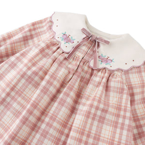 Pink checkered dress with floral embroidery on a white background