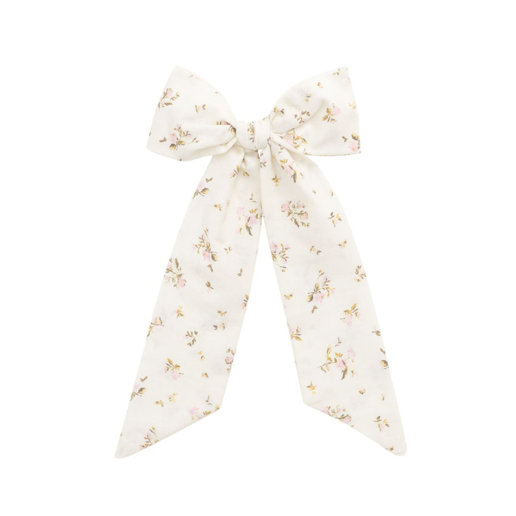 Floral scarf tied into a bow on a white background