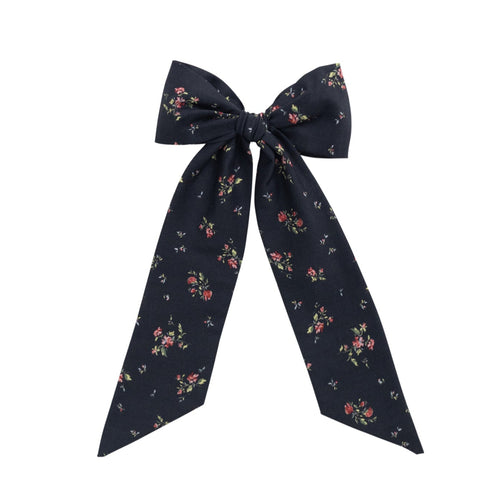 Navy floral bow on a white background