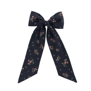 Navy floral bow on a white background