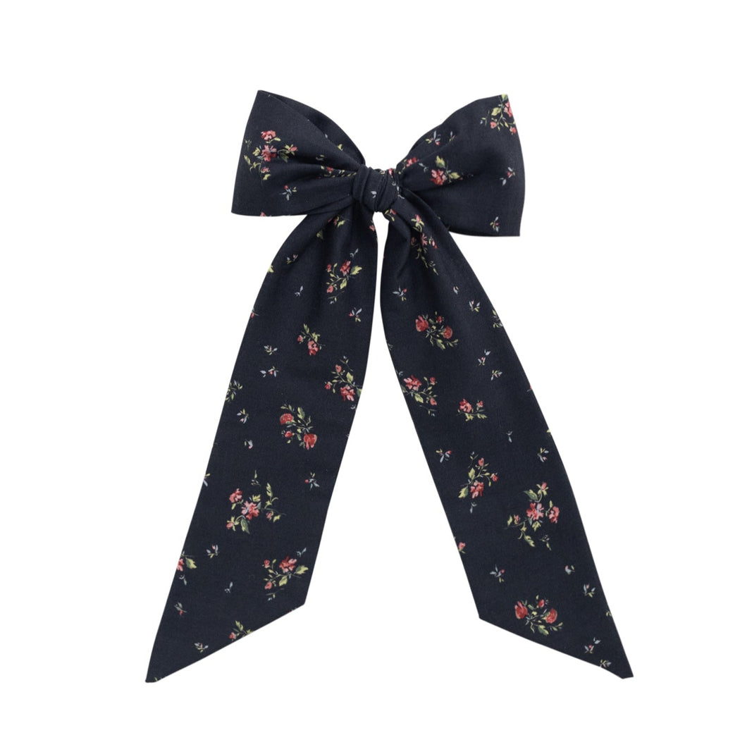Navy floral bow on a white background