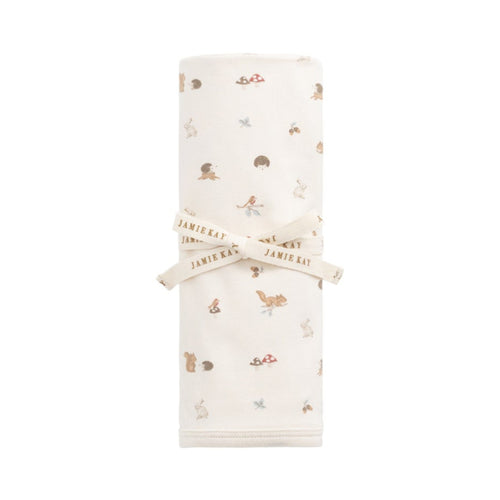 White swaddle blanket with gold floral pattern on a white background