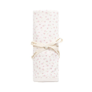 Folded fabric with a subtle pattern on a white background