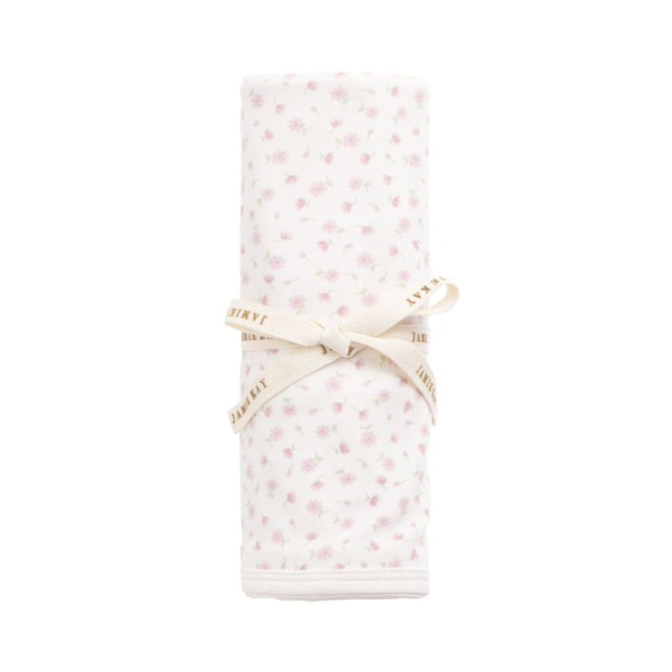 Folded fabric with a subtle pattern on a white background