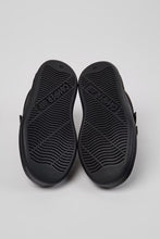 將圖片載入圖庫檢視器 Black rubber outsoles of a pair of shoes, shown from above on a light gray background.