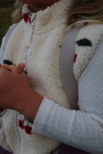 Load image into Gallery viewer, Close-up of a person wearing a white fleece jacket with colorful patterns.