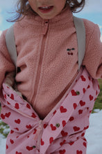 Load image into Gallery viewer, Child wearing a pink fleece jacket with heart pattern in a snowy outdoor setting