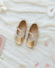 Load image into Gallery viewer, Gold metallic T-strap ballet flats from Noralee, styled with socks or tights, showcasing elegant footwear for women.