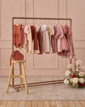 Load image into Gallery viewer, Noralee Luna Dress Bouquet, a stylish dress featuring floral patterns, displayed on a rack with vibrant colors and elegant design.