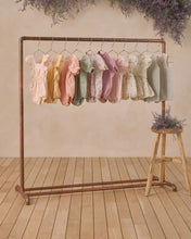 Load image into Gallery viewer, Noralee Lyla Lavender Floral Romper displayed on a hanger with a floral pattern and lightweight fabric.