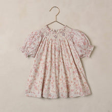Load image into Gallery viewer, Floral dress on a hanger against a beige background