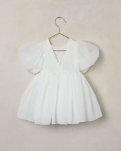 Load image into Gallery viewer, White dress with puffed sleeves on a hanger against a beige background