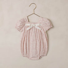 Load image into Gallery viewer, Lavender floral Noralee Lyla Romper displayed on a hanger, showcasing its soft fabric and delicate floral print.