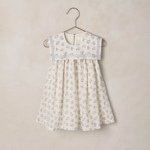 Load image into Gallery viewer, Floral dress hanging on a hanger against a beige background