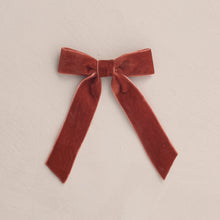 Load image into Gallery viewer, Red velvet bow on a beige background