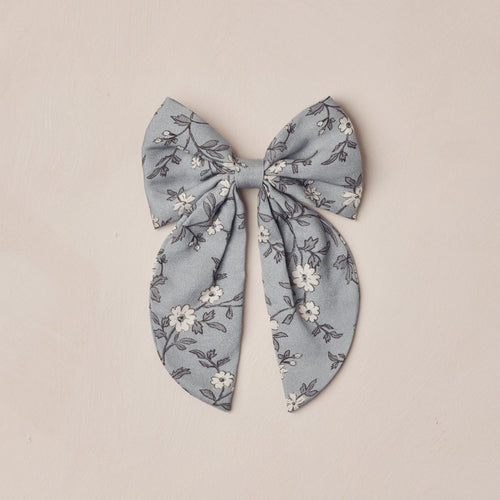 Floral patterned bow on a beige background