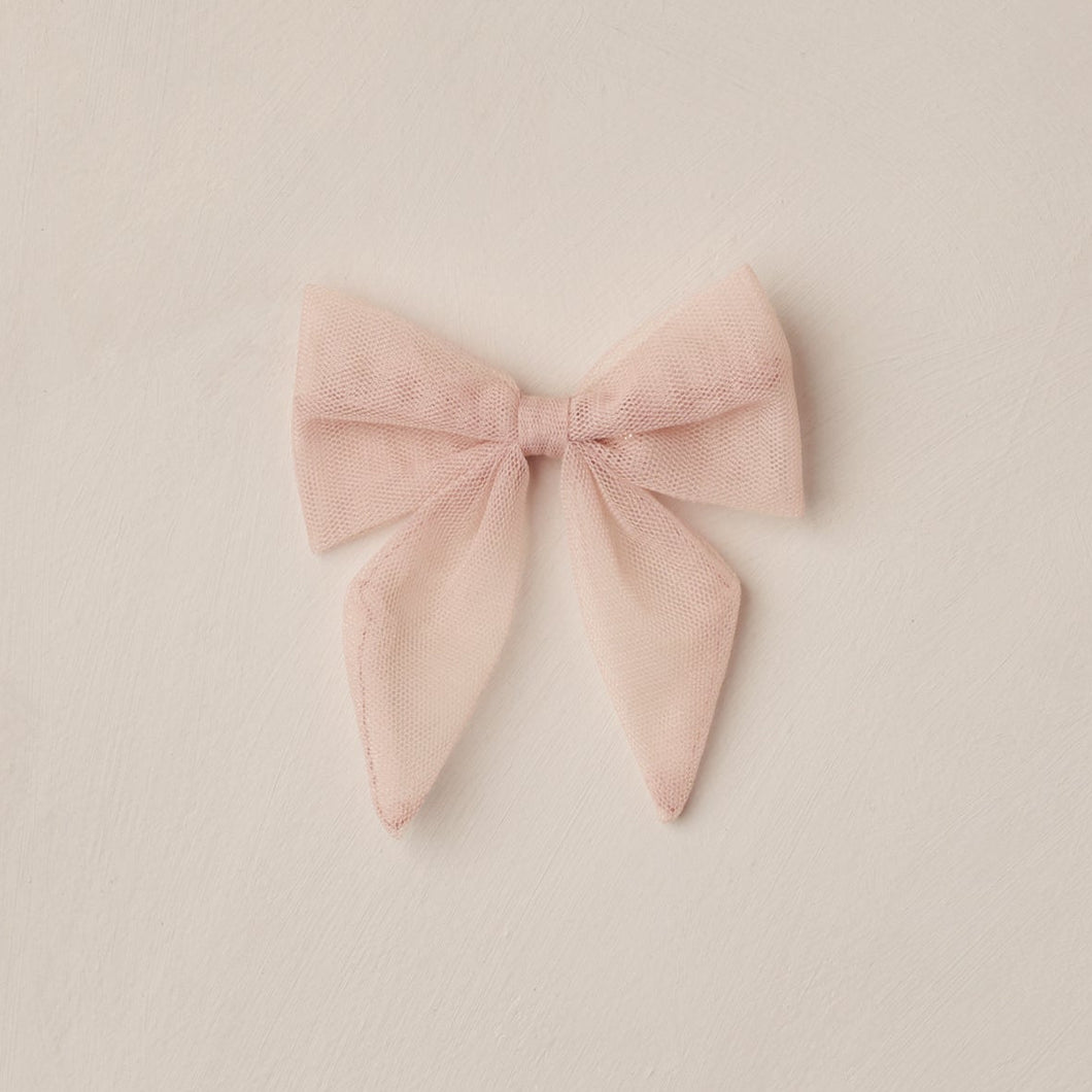 Pink bow on a beige background