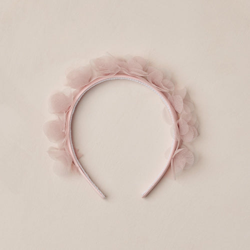 Pink headband with floral details on a beige background