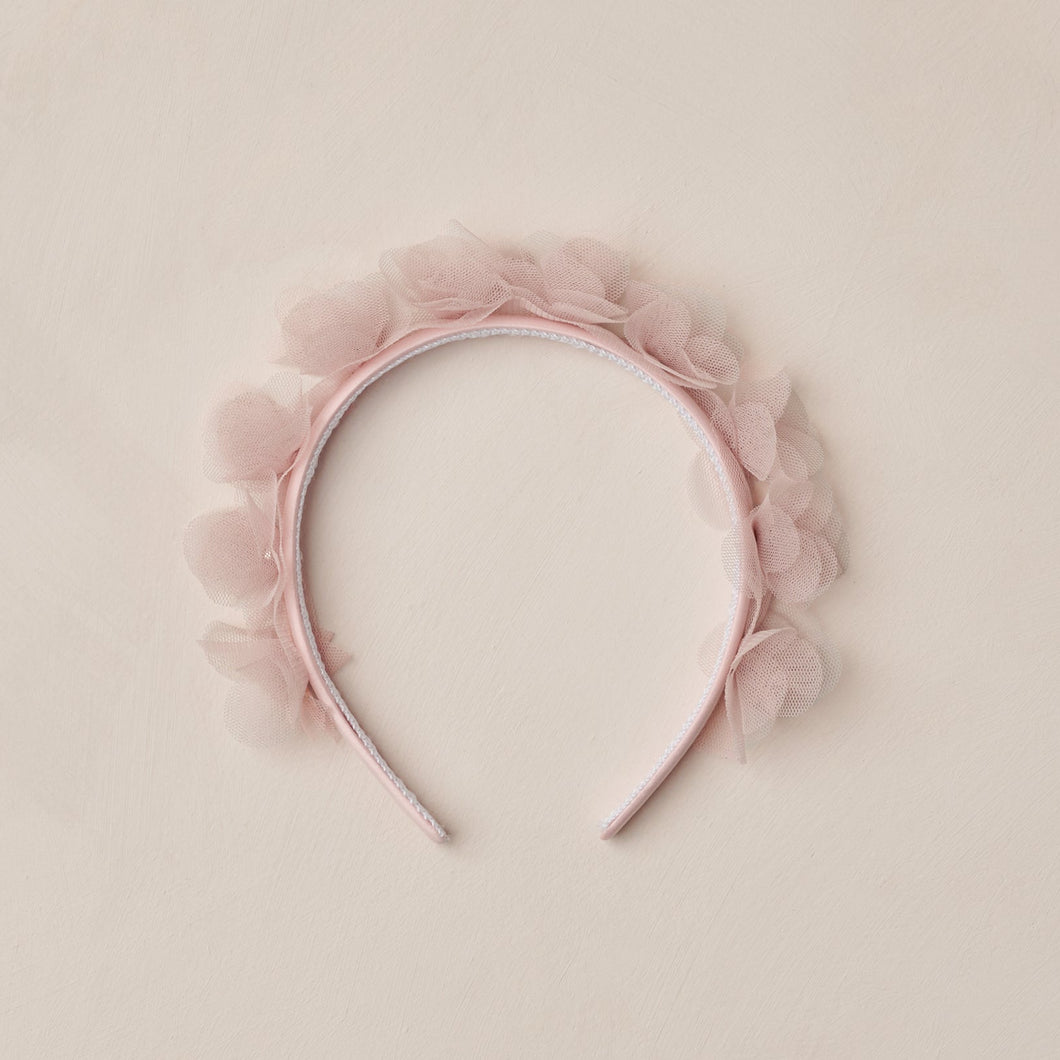 Pink headband with floral details on a beige background