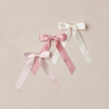 Load image into Gallery viewer, Three satin ribbons in pink, white, and light pink on a beige background