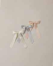 Load image into Gallery viewer, Ivory satin ribbon bow headband with pearl accents by Noralee, featuring a misty, elegant design for special occasions.