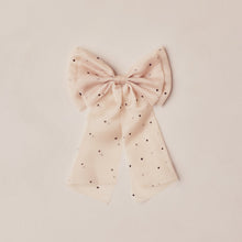 Load image into Gallery viewer, Pink bow with black polka dots on a beige background