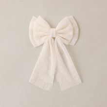 Load image into Gallery viewer, Noralee Alice Bow Ivory headband featuring a soft, elegant bow design, perfect for adding a charming touch to any outfit.