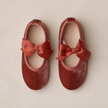 Load image into Gallery viewer, Pair of red velvet shoes with bows on a beige background