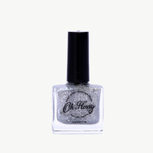 Load image into Gallery viewer, Nail polish bottle with glittery finish and black cap on a white background