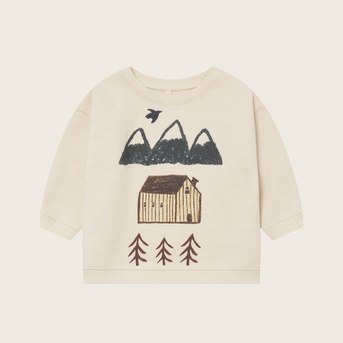 Children's sweater with nature-themed design on a beige background