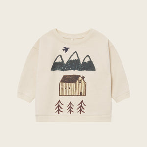 Children's sweater with nature-themed design on a beige background