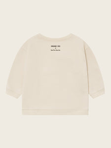 Beige t-shirt with text on the back against a light beige background