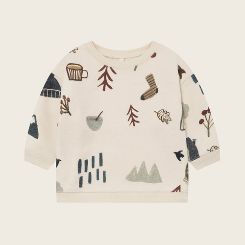 Children's sweatshirt with nature-themed graphics on a beige background