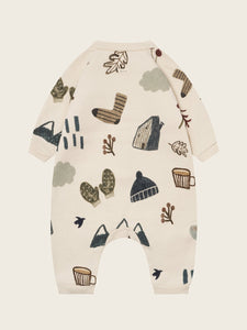 Baby onesie with winter-themed pattern on a beige background