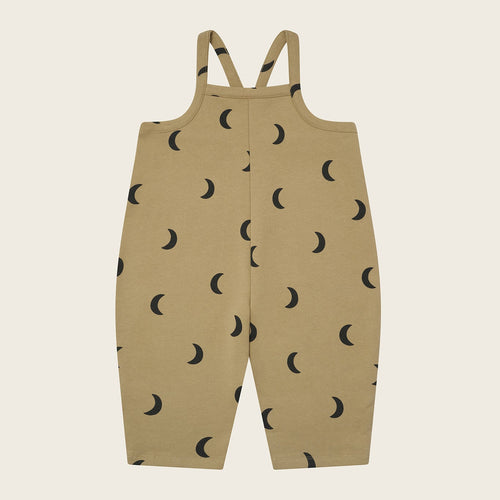 Beige overalls with black moon pattern on a beige background