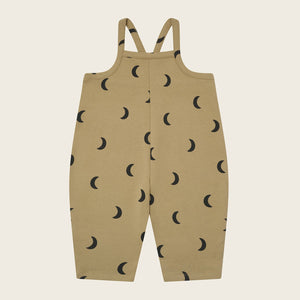 Beige overalls with black moon pattern on a beige background