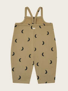 Beige overalls with black moon pattern on a beige background