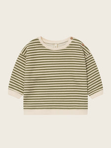 Green and white striped shirt on a beige background