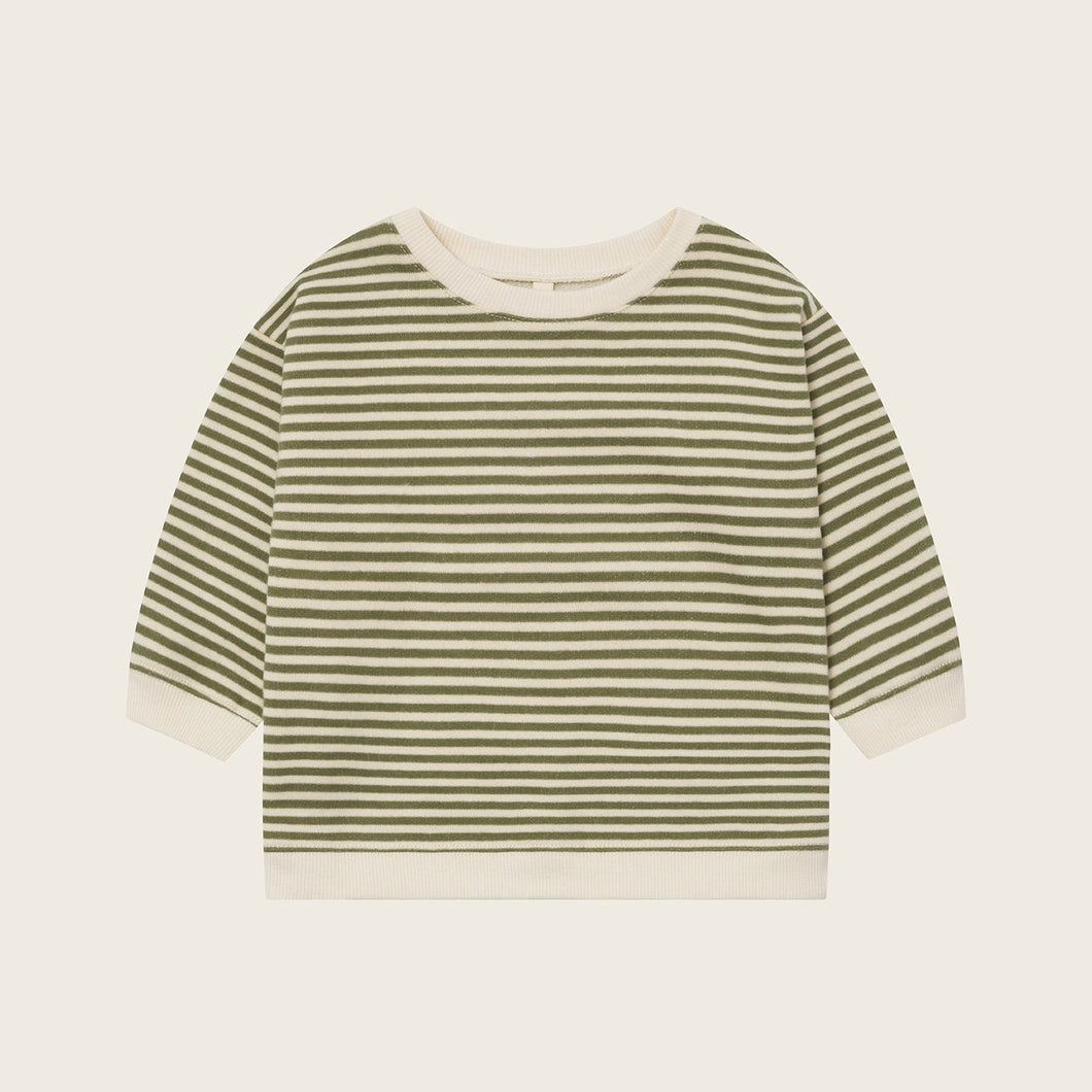 Striped shirt with green and white horizontal stripes on a beige background
