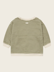 Green and white striped shirt on a beige background