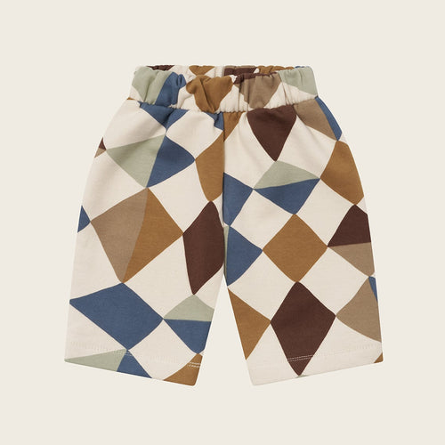 Geometric patterned shorts on a beige background