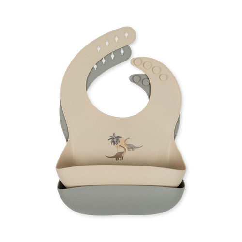Beige and gray bib with dinosaur design on a white background