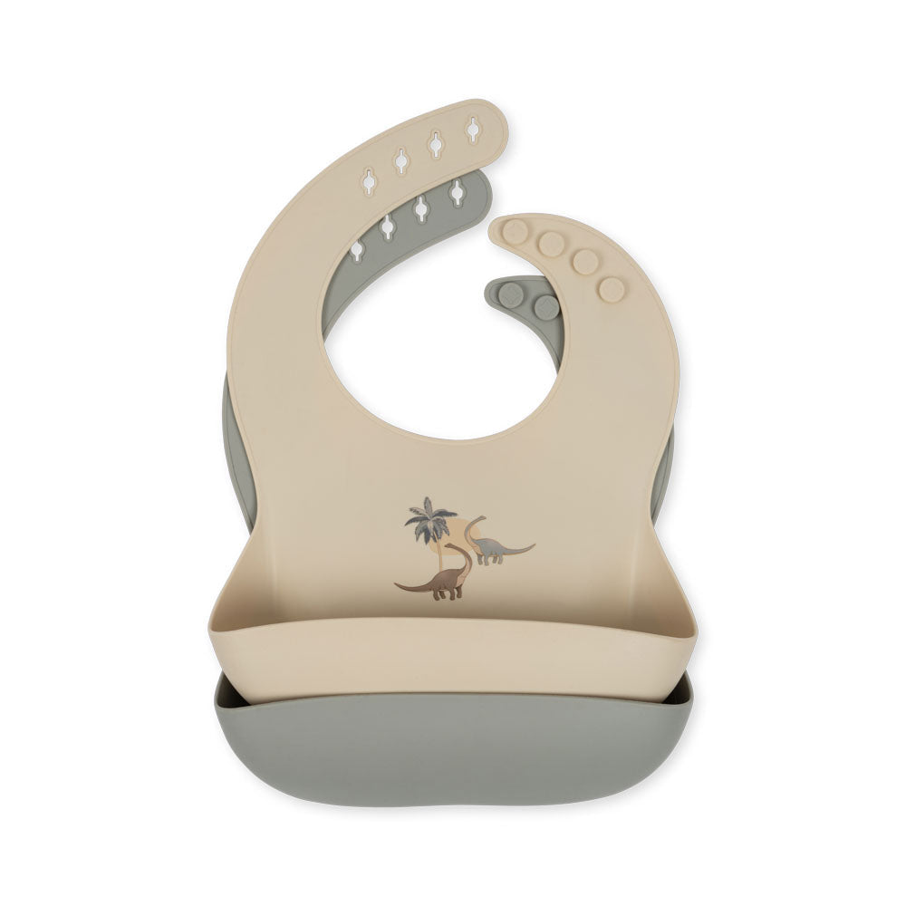 Beige and gray bib with dinosaur design on a white background
