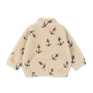 Beige fleece jacket with black anchor pattern on a white background