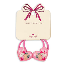 Load image into Gallery viewer, Pink heart-shaped hair ties with cartoon characters on a beige card with a pink bow, branded &#39;Lavish Angel&#39;.