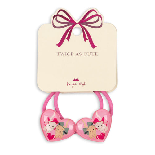 Pink heart-shaped hair ties with cartoon characters on a beige card with a pink bow, branded 'Lavish Angel'.