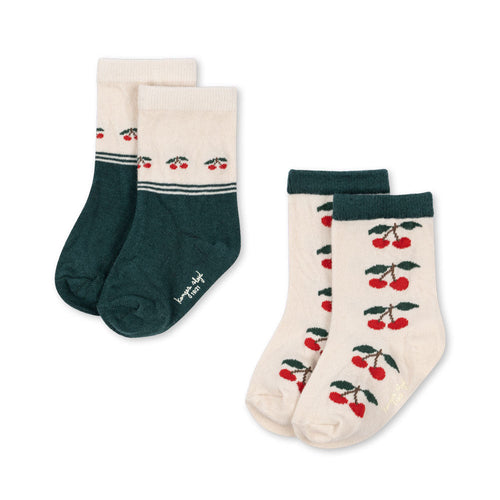 Two pairs of socks with different designs on a white background