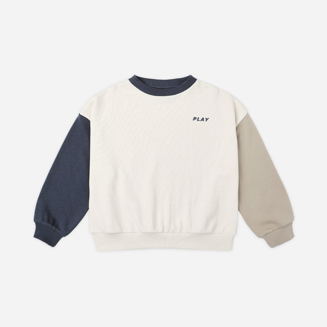 Color-blocked sweatshirt with 'PLAY' text on a white background